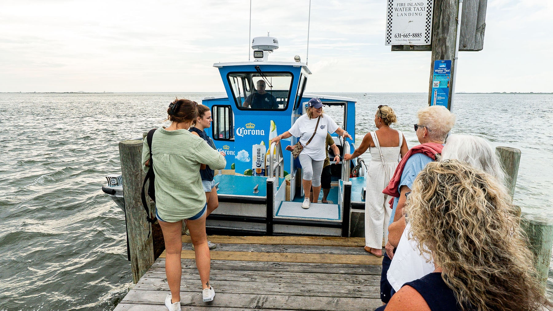 People disembarking water taxi while others wait to board